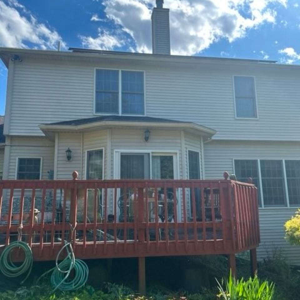 Freshly washed two-story home exterior with red deck after pressure washing in Harrisburg PA