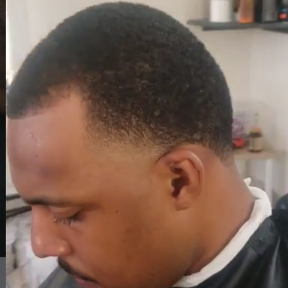 Low fade haircut with smooth blend on short hair at Bronx NY barbershop Jeff Barber Services
