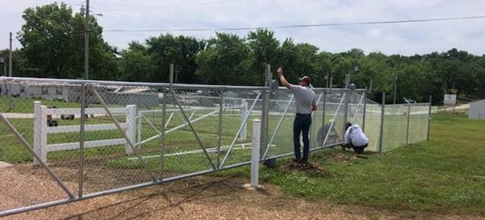 Dore team installing commercial chain link fence