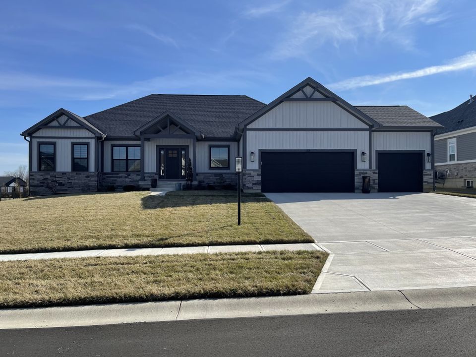 Modern single-story home with a professionally installed gray architectural asphalt shingle roof by E & D Roofing, Inc.