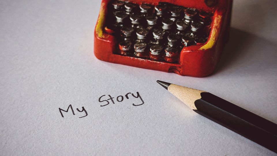 The words "My Story" written in pencil on a piece of paper