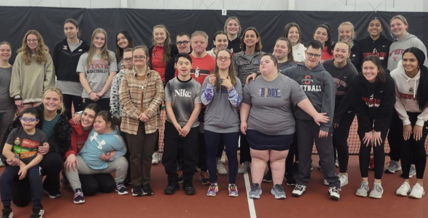Group photo of participants, volunteers, and Youngstown State students during an adaptive tennis program hosted by the Down Syndrome Association of the Valley.