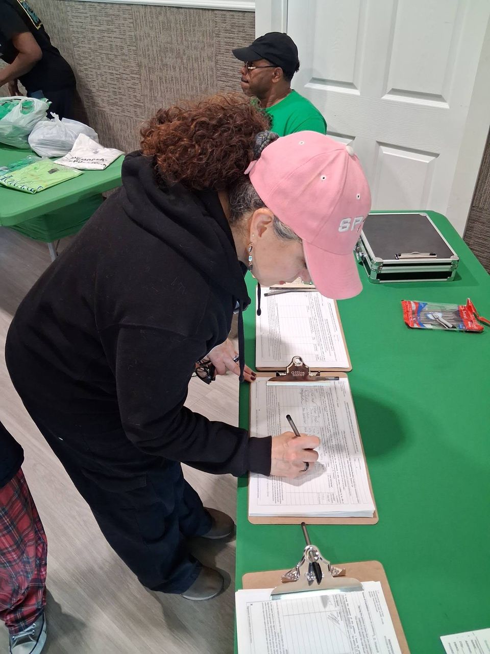 Person signing petition at L.D. Howard event