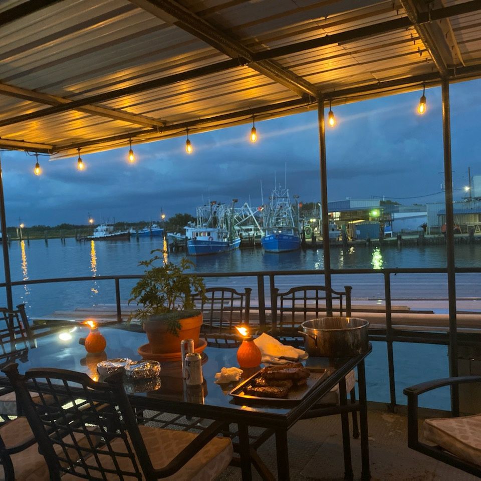 Candle lit table a dusk in Venice, La. over looking the water.