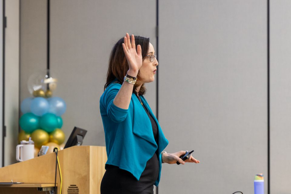 Woman standing with arm raised