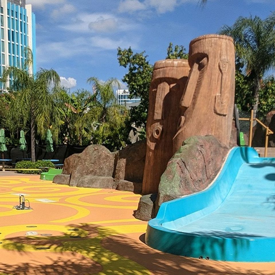 Outdoor play area with EverStone Flex safety flooring and a slide.