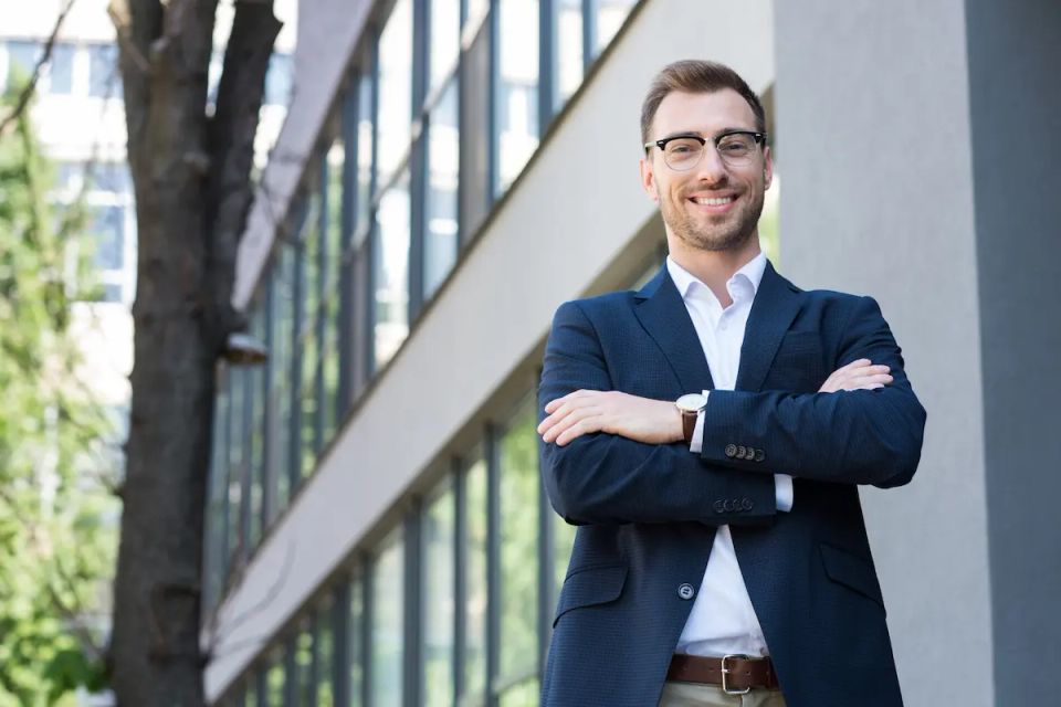 Vistacreate 195983250 stock photo smiling professional businessman formal wear posing crossed arms
