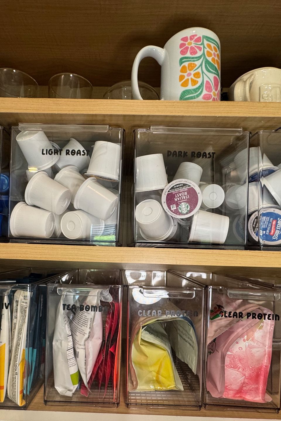 clear containers with coffee tea packets on shelves