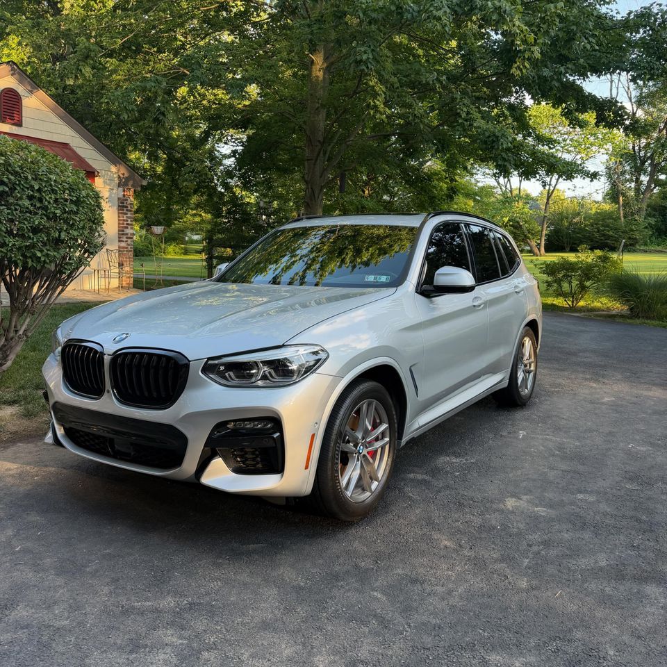 Front view of a silver BMW X3 M Sport shining after a driveway detail at a Wilmington home