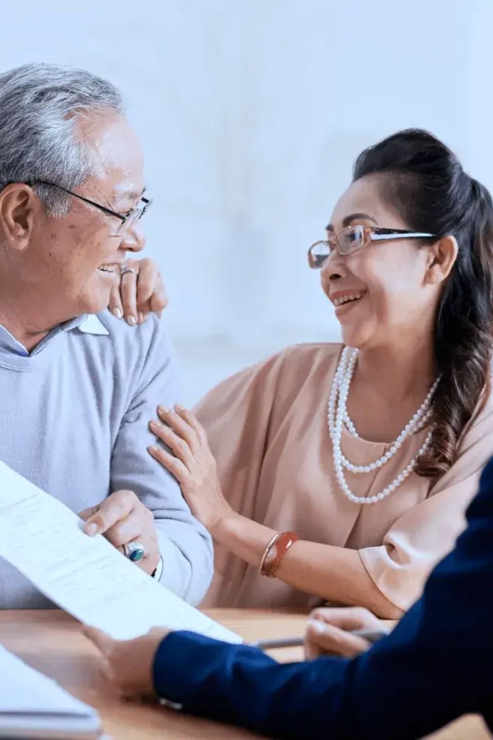 Happy elderly couple paperwork
