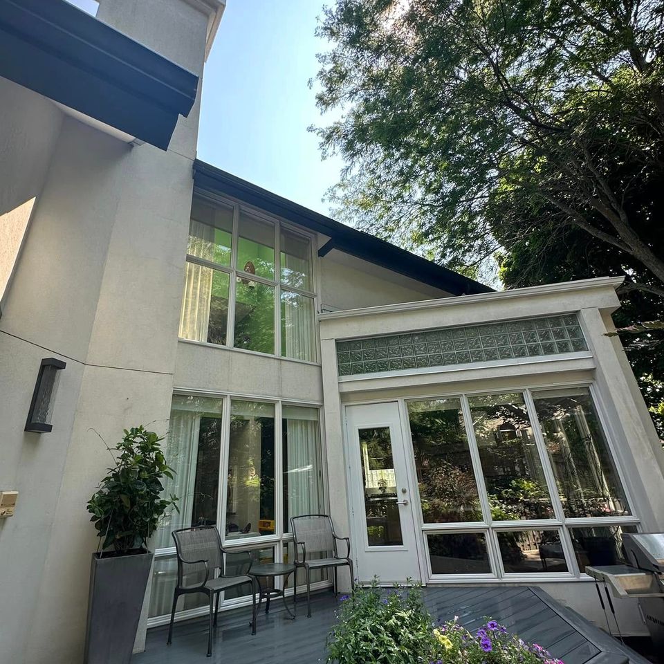 Clean windows and stucco exterior beside a back deck at a Tillsonburg Ontario home