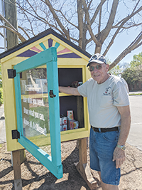 Jim potter puts canned goods into gracie's blessing box