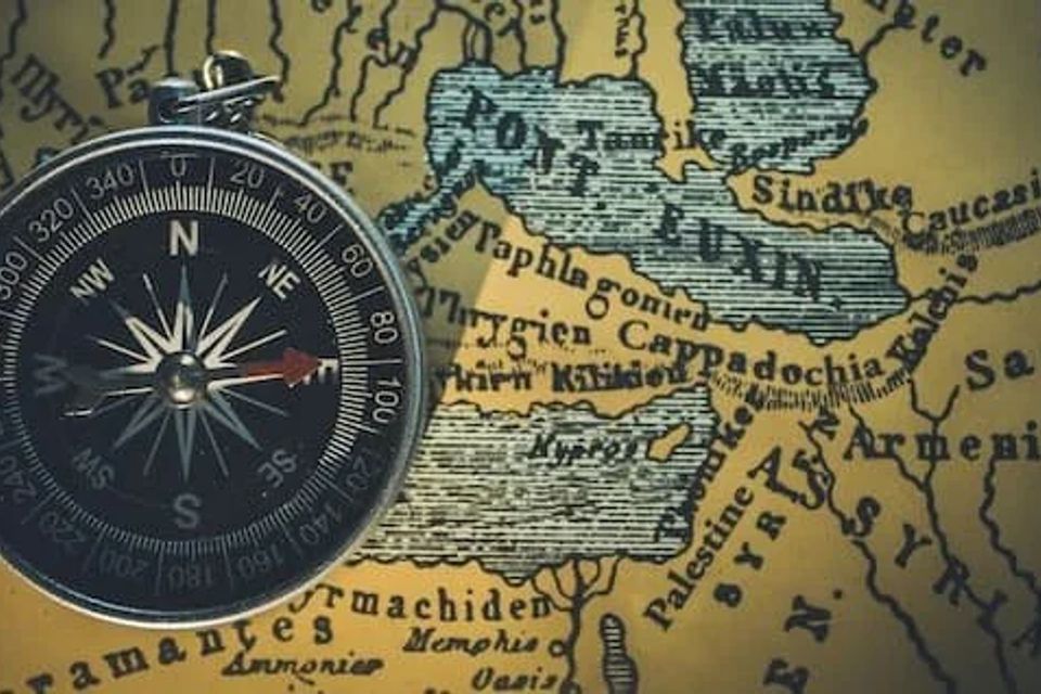 Compass sitting on a map 
