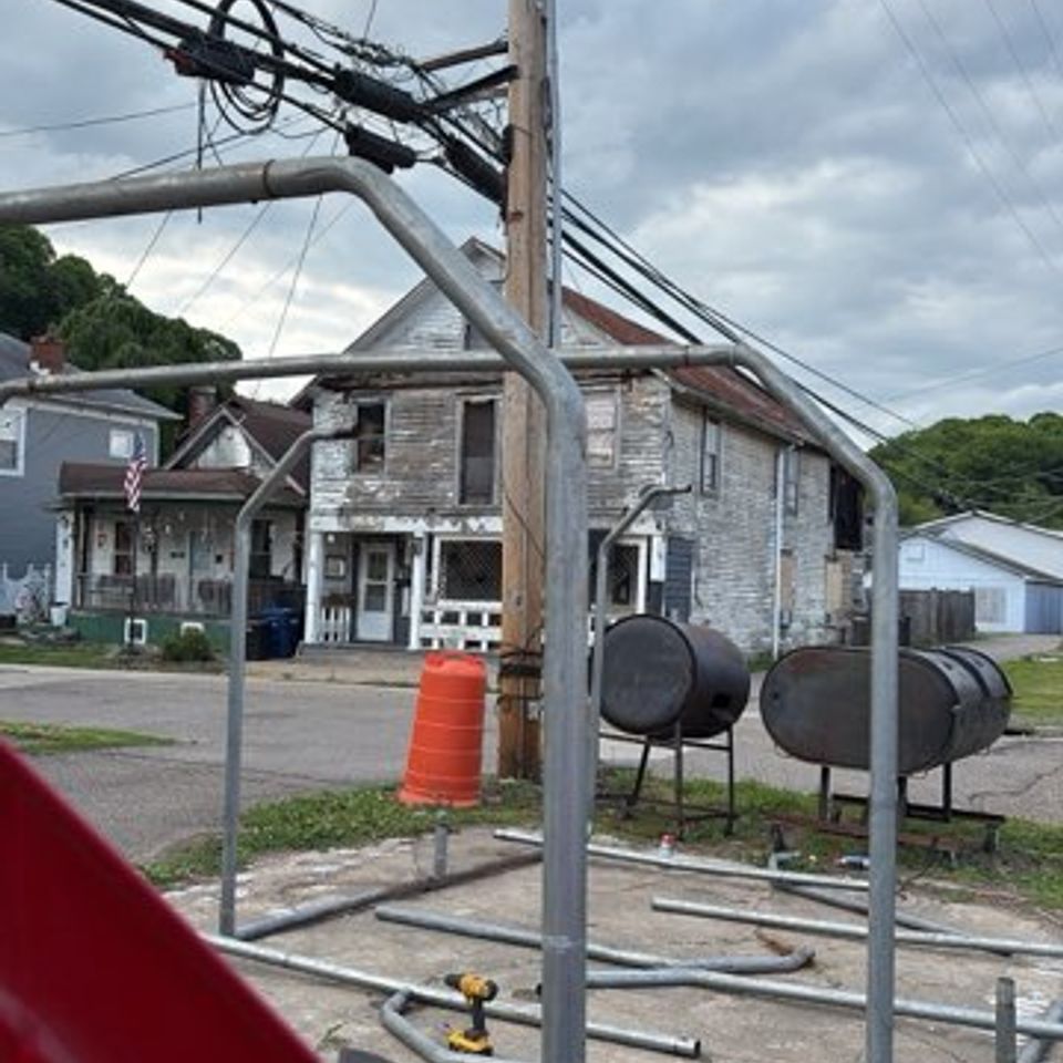 Multiple BBQ pits at Lickers Hometown BBQ used for slow-smoking meats and preparing authentic barbecue.