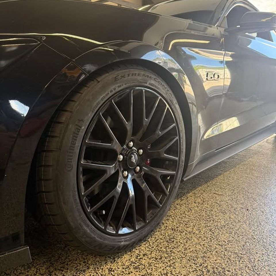 Black Ford Mustang 5.0 with new black multi-spoke wheels and Continental tires in Claymont DE