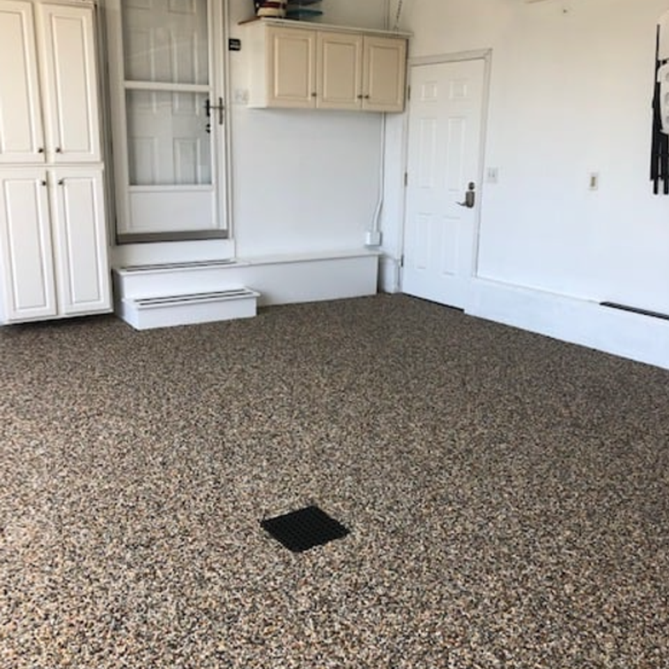 Residential garage featuring an EverStone decorative stone flooring system.
