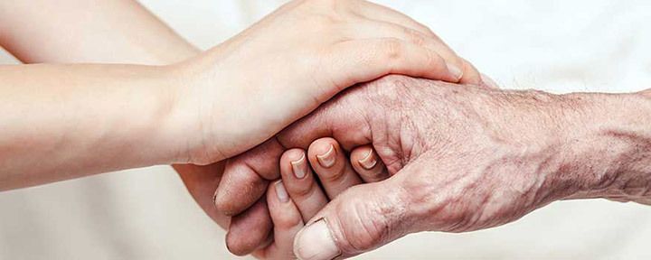 Caregiver holding hands care family