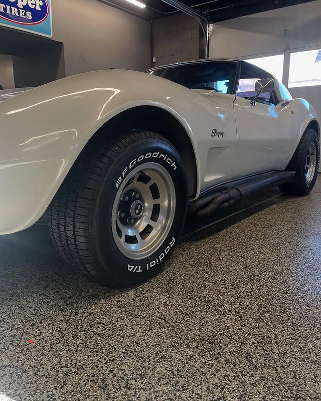 White Chevy Corvette Stingray with BFGoodrich Radial T/A tires inside tire shop in Claymont DE