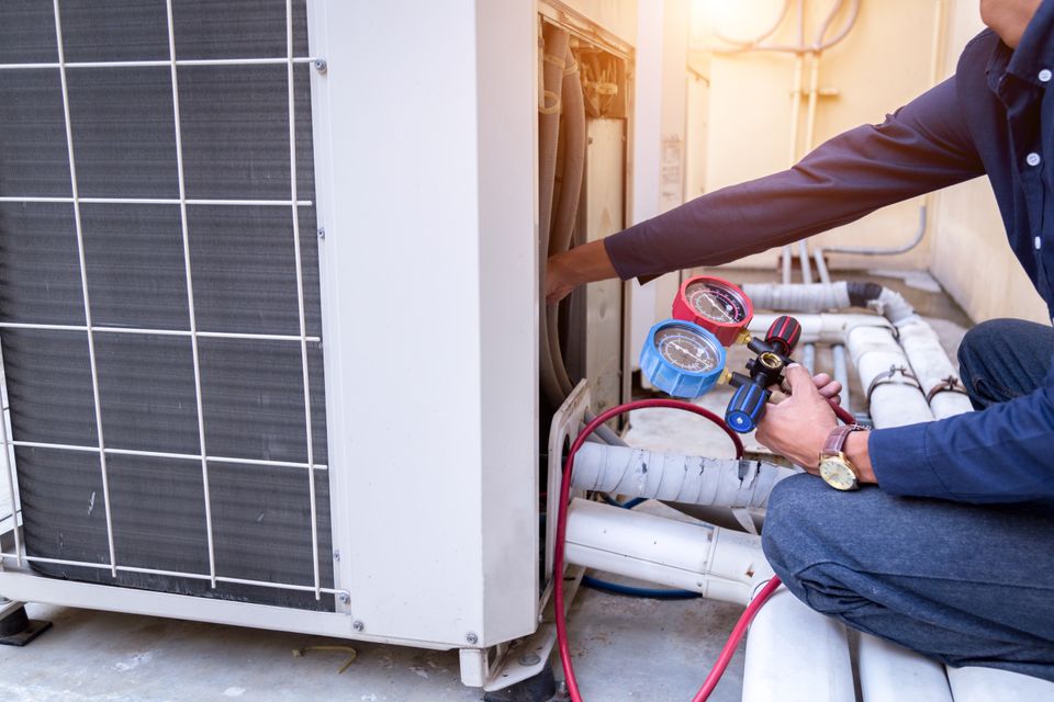 Technician is checking air conditioner measuring equipment filling air conditioners (2)
