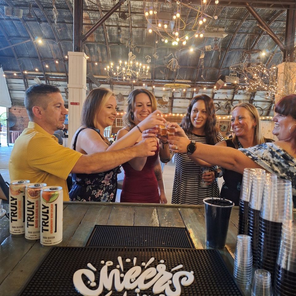 Wedding guests raising drinks together at a full bar setup at Chestnut Ridge Park & Campground