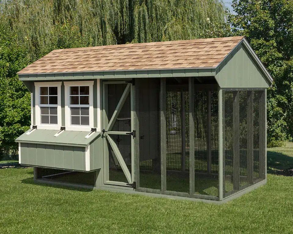 Green Quaker chicken coop with nesting box and wire run installed on a Knoxville TN lawn