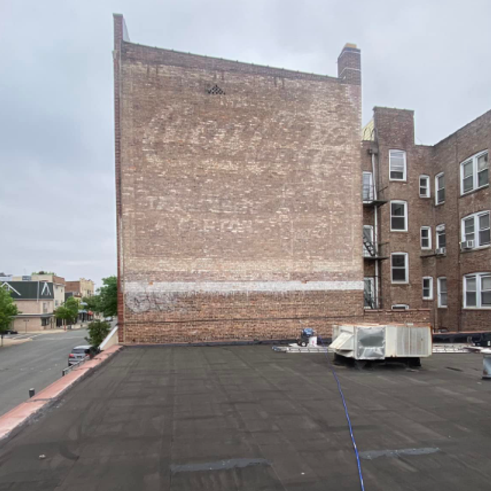 Commercial brick multidwelling surface refinishing building before