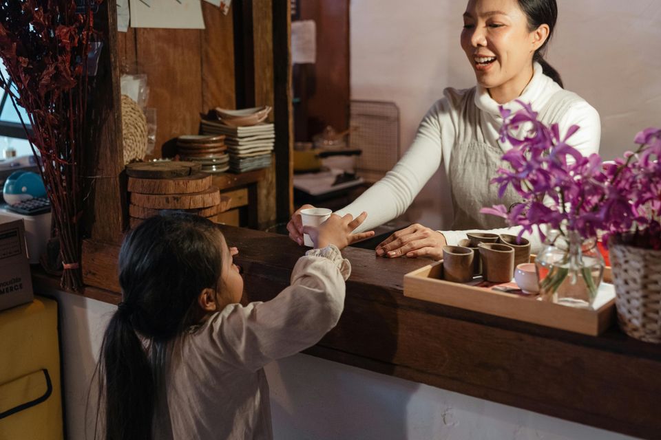 Little girl purchasing from a business owner