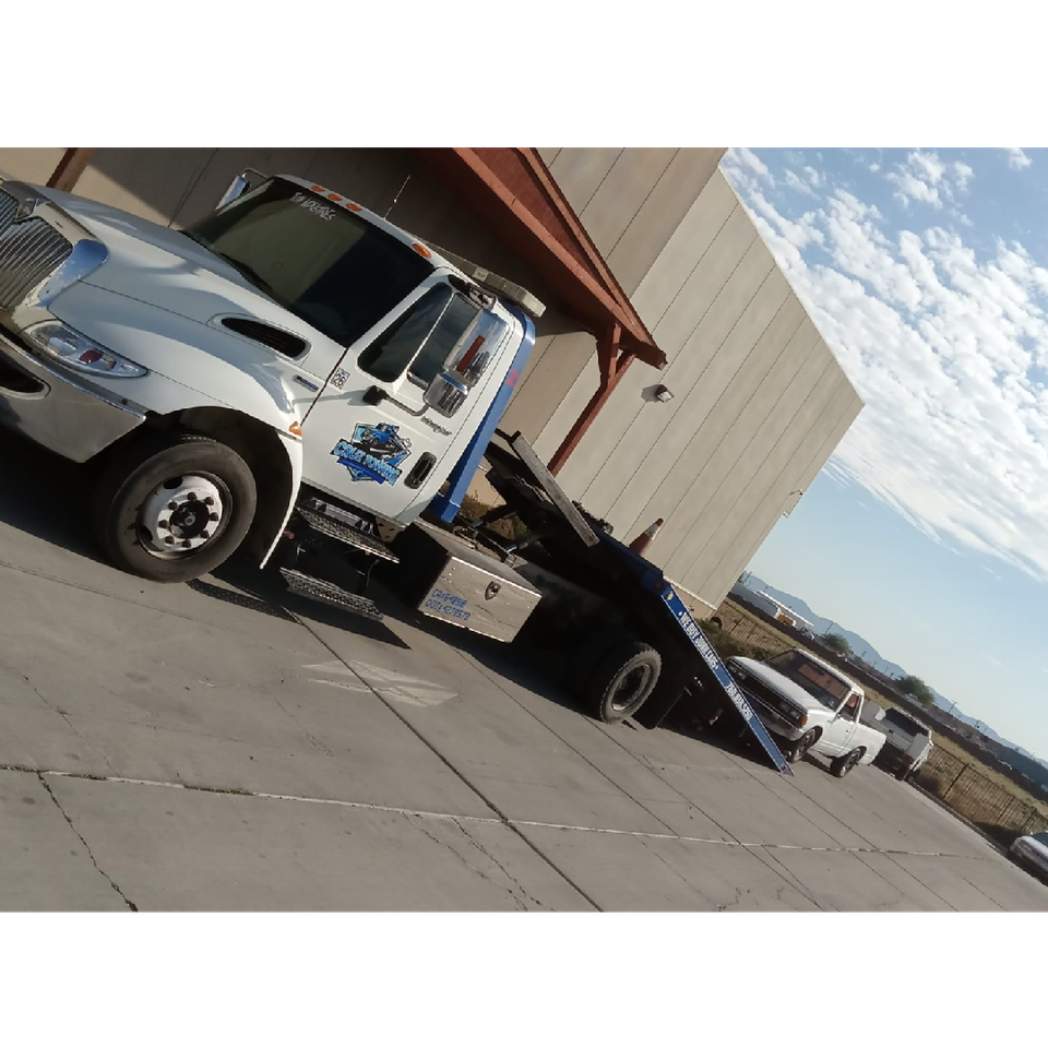Image of Cruz Auto Repair and Towing Tow Truck and disabled mini pick up made by Toyota Motor Car Company.