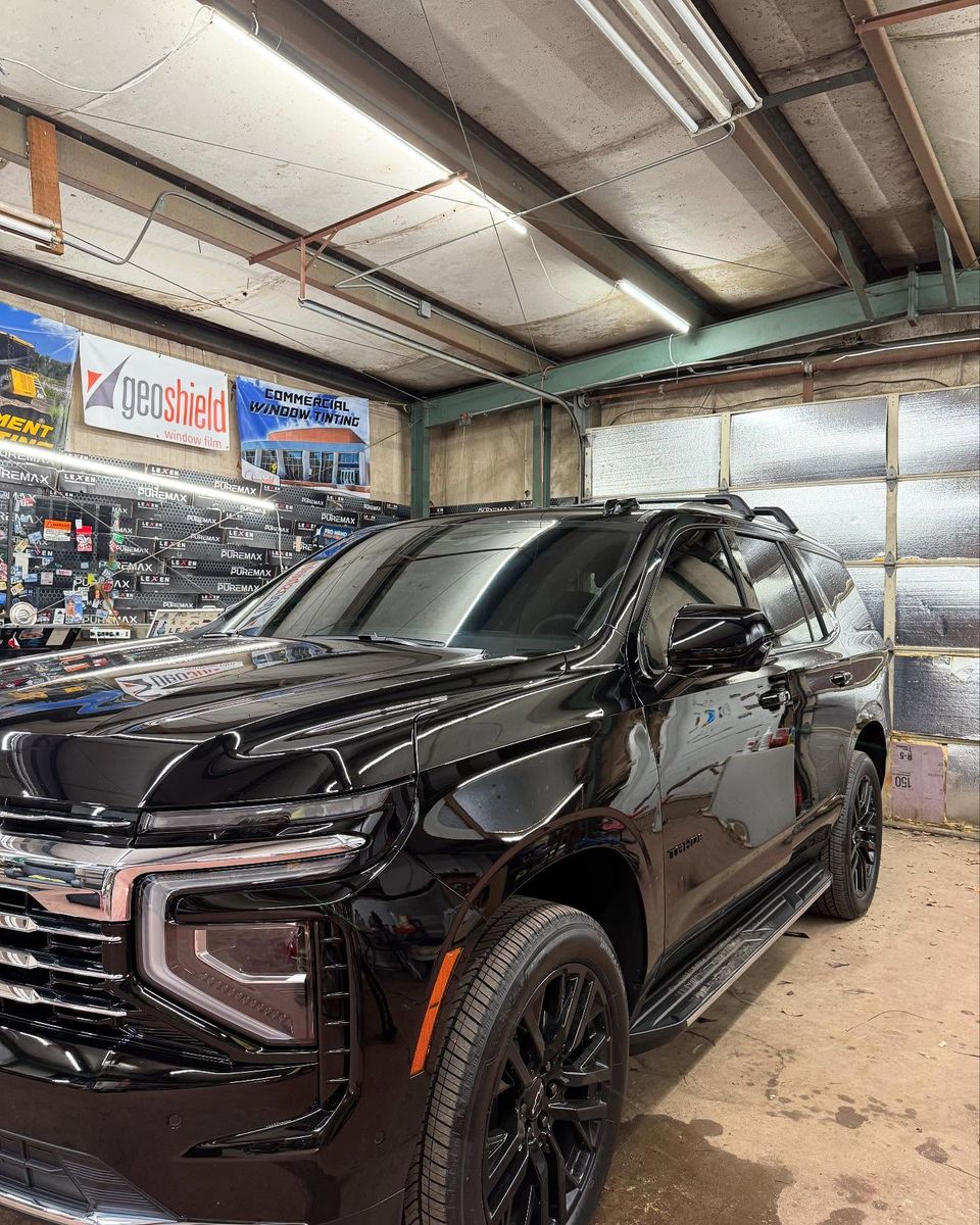 Black Chevrolet Tahoe with dark tinted windows after auto tint service in Moyock NC