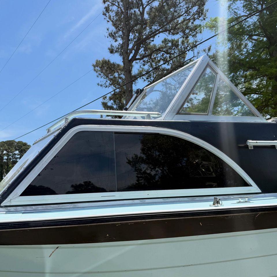 Boat windshield and side glass with marine window tint applied on a classic cabin boat