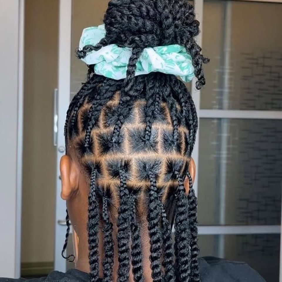 Neatly parted jumbo twists gathered with a scrunchie after a braiding service in Los Angeles CA
