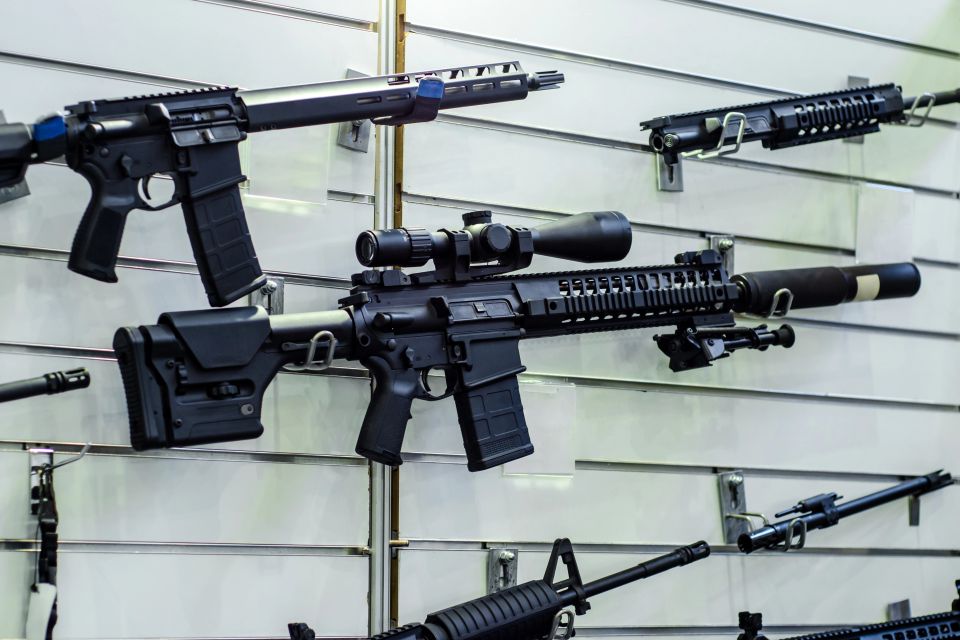 Modern sporting rifles displayed on a slatwall in a gun shop