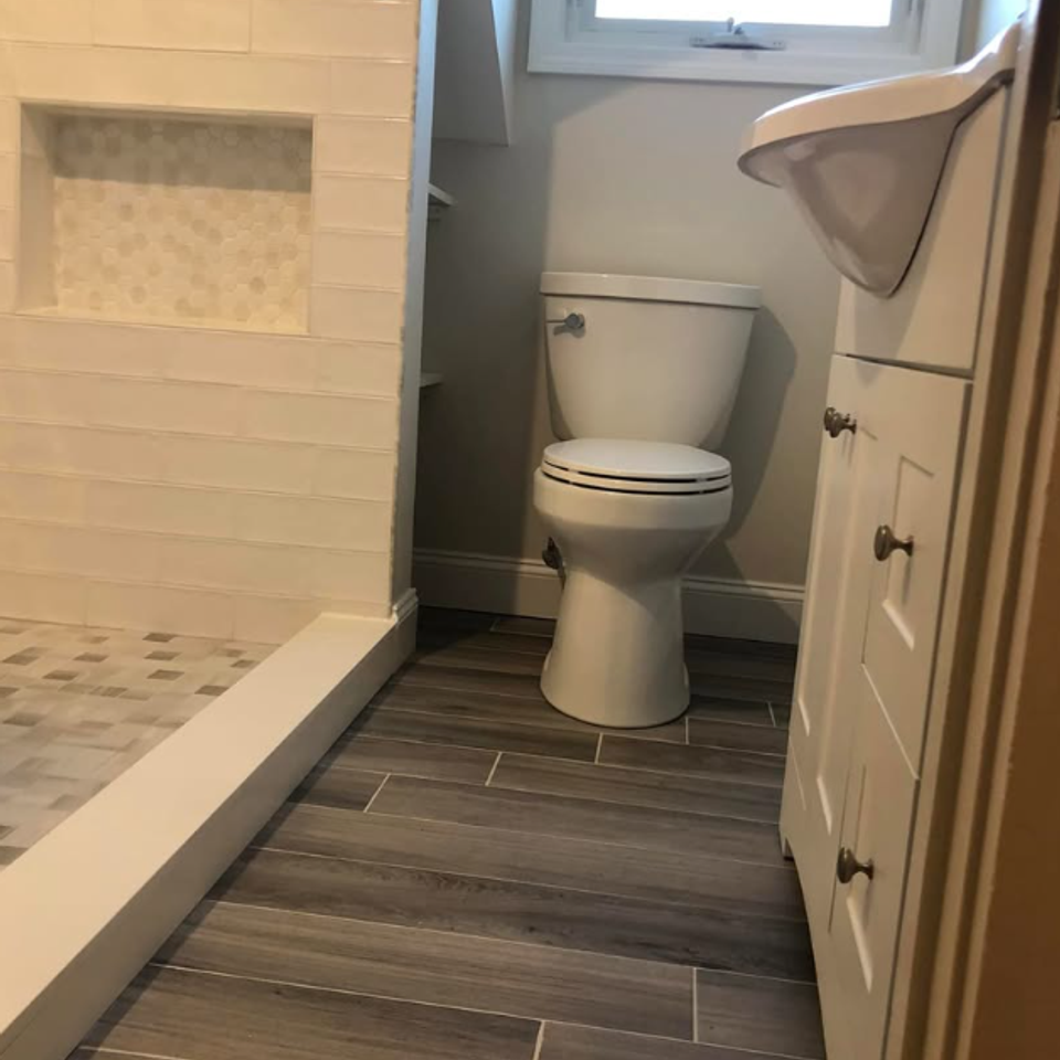 Narrow bathroom wood look tile floor