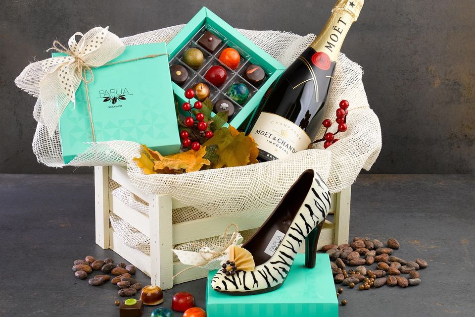 Gift crate with Moët champagne, assorted chocolates, zebra-print shoe, jars of treats, and decorative berries and leaves Chocolate