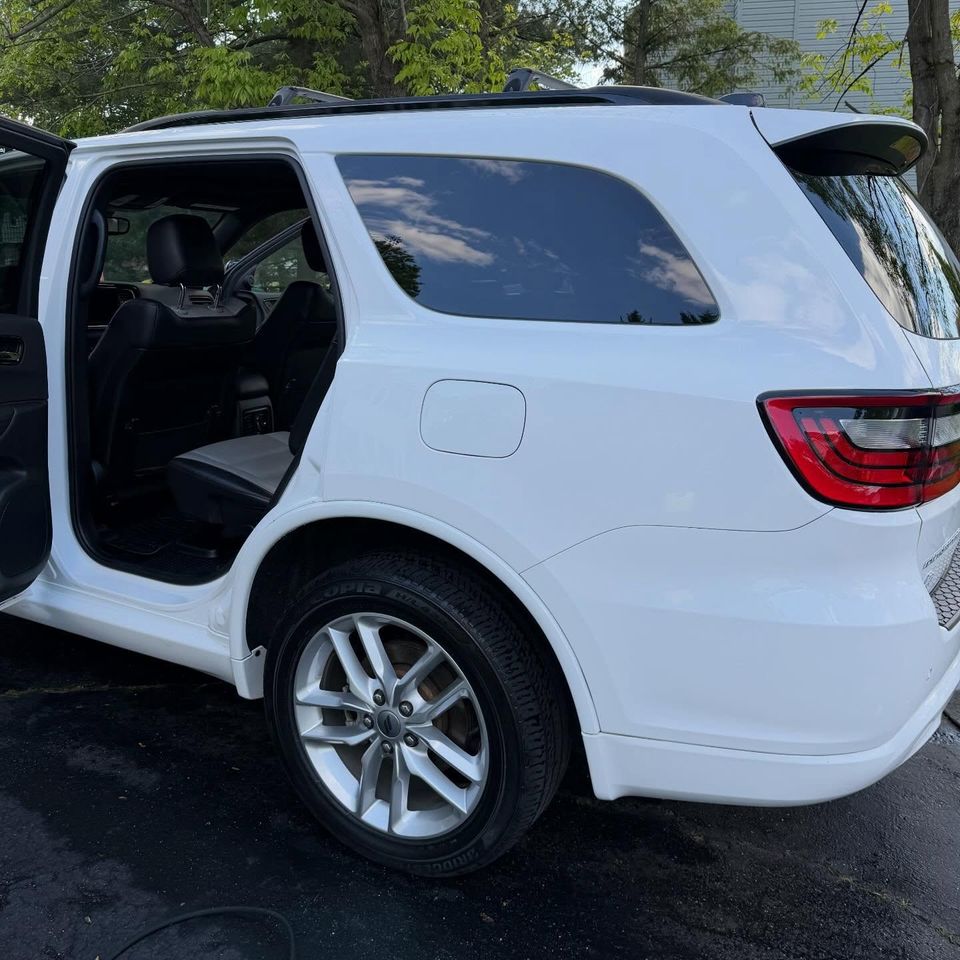 White Dodge Durango with dressed tires and spotless rear interior after a full detail