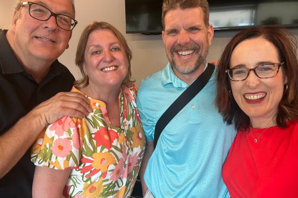 Two men and two women smiling for photo