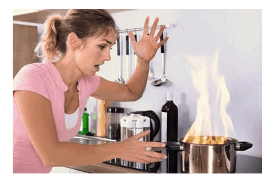 Women at stove pot on fire