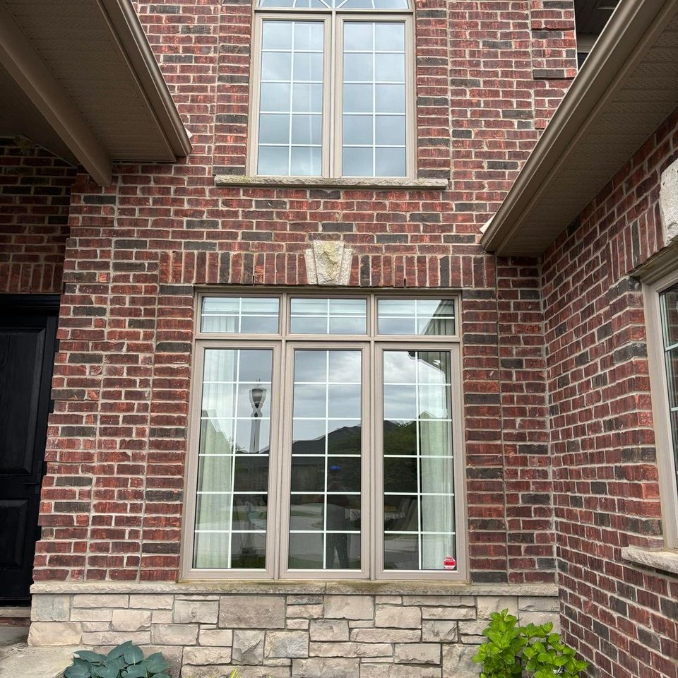 Streak-free windows on a brick home exterior after a professional window washing