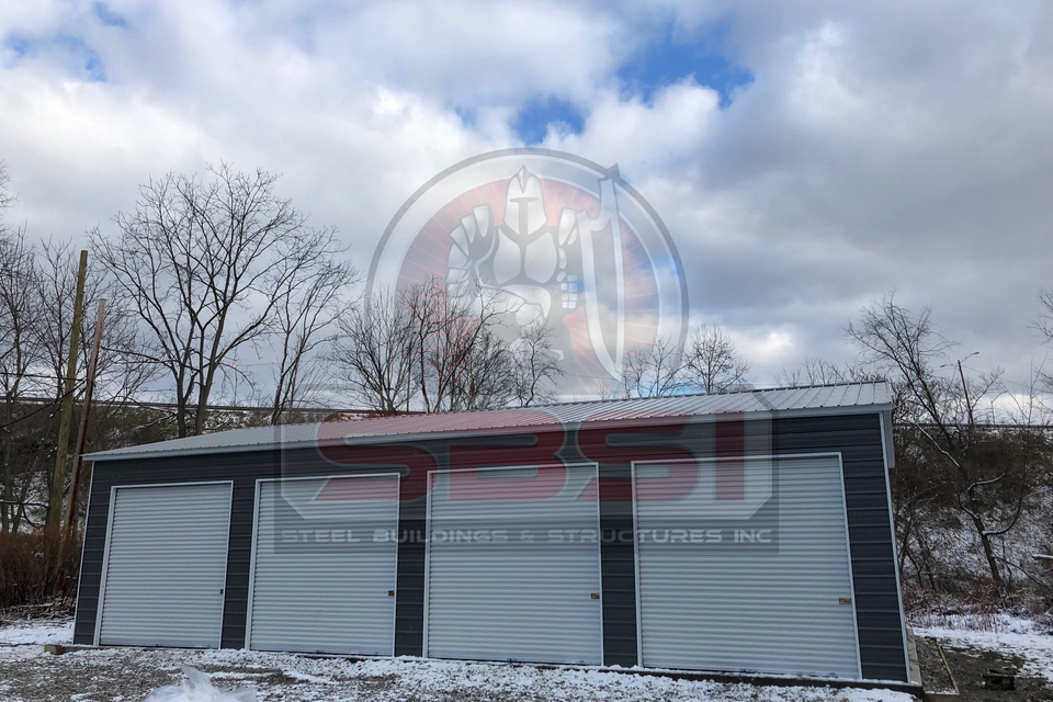 Blue steel garage with white roll up doors in snowy lot with SBSI watermark representing steel garages in Alabama