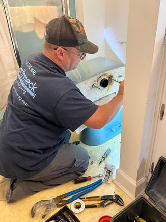 Kenny plumber working on a bathroom toilet repair