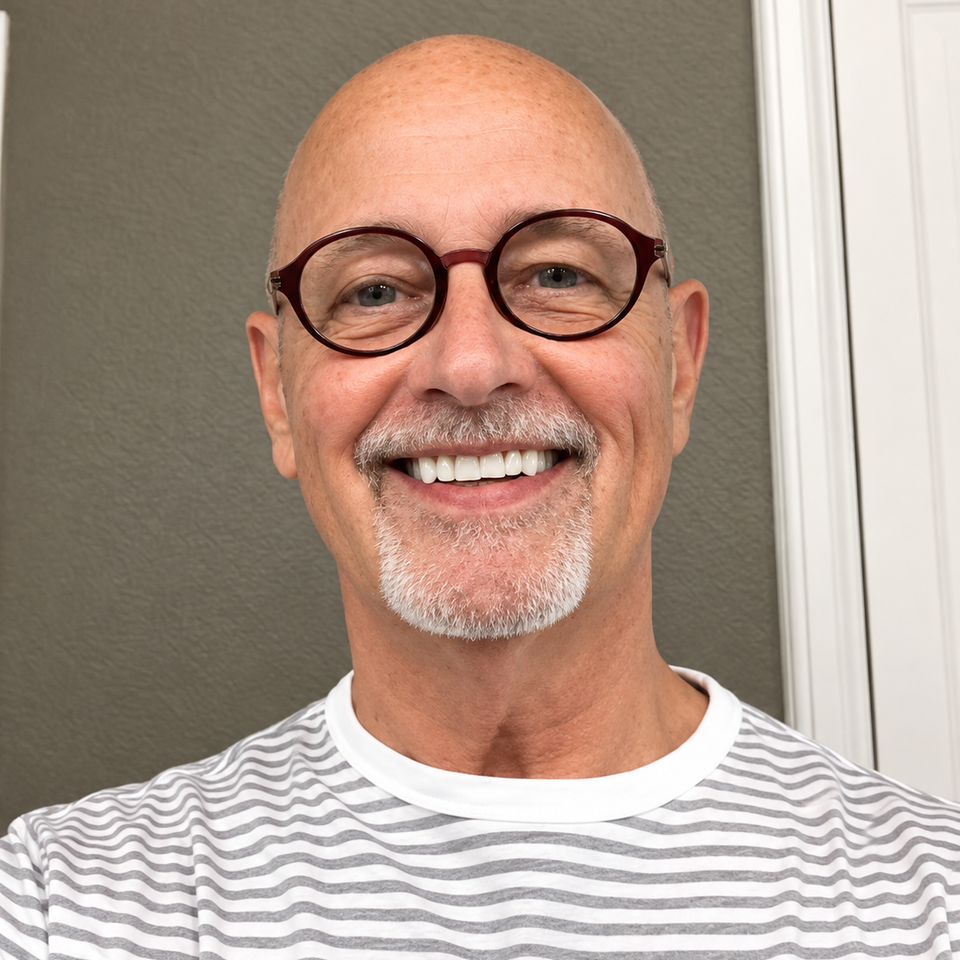 Smiling man in round glasses