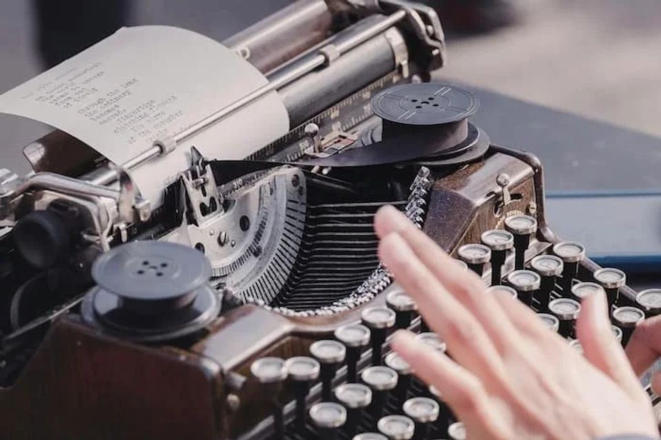 Someone typing with an old timey typewriter 