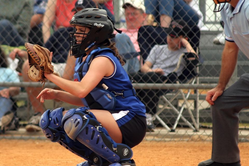 Female softball player focused during game due to an adequate amount of sleep night prior
