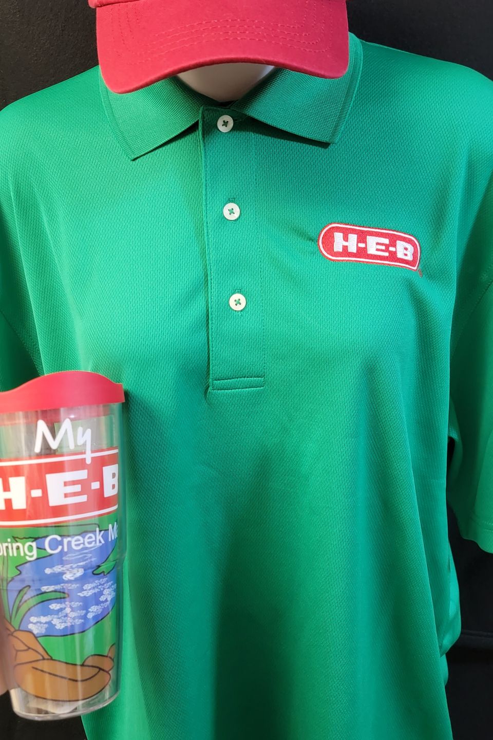 Embroidery Example - HEB logo on green polo, HEB rhinestone bling logo on cap. 