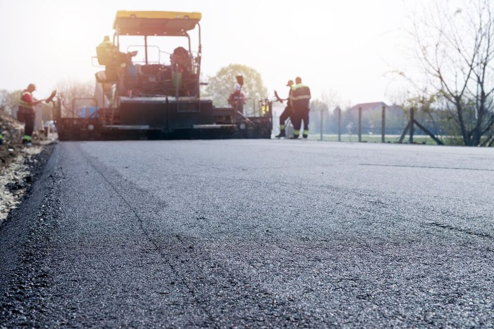 Workers placing new coating asphalt road 342744 601