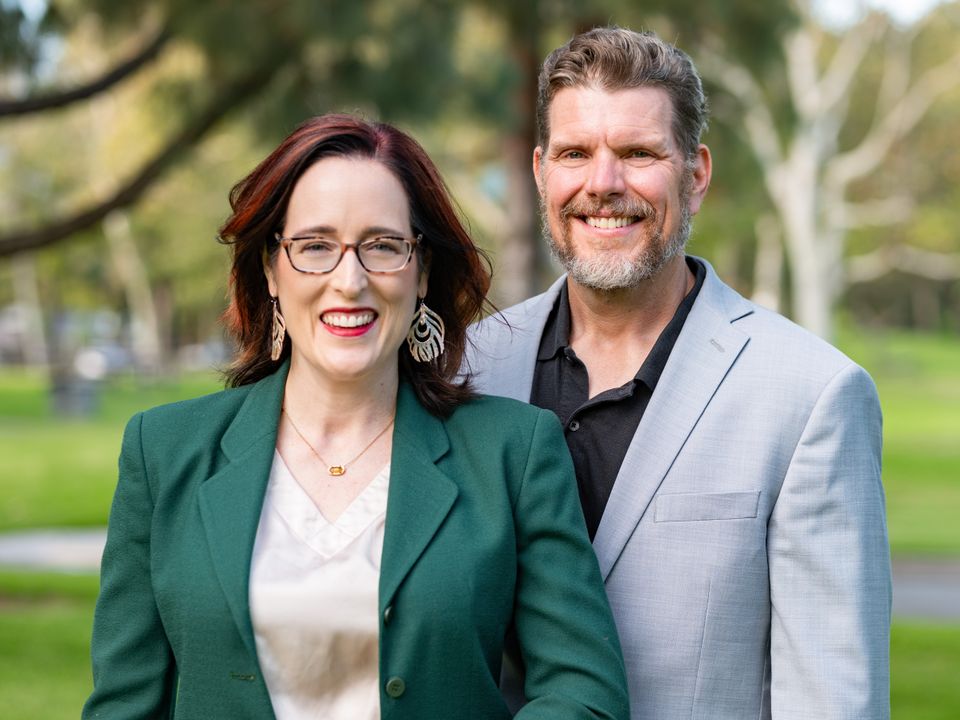 Man and woman posing outdoors