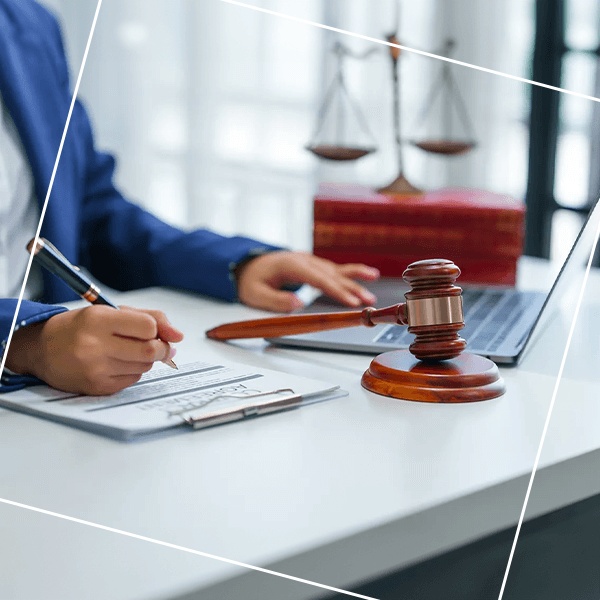 Person at desk with balance scales and gavel