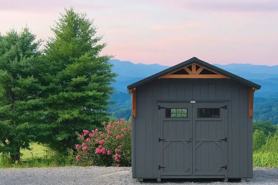 Gray Alpine cottage shed with double doors and wood accents overlooking East Tennessee mountains