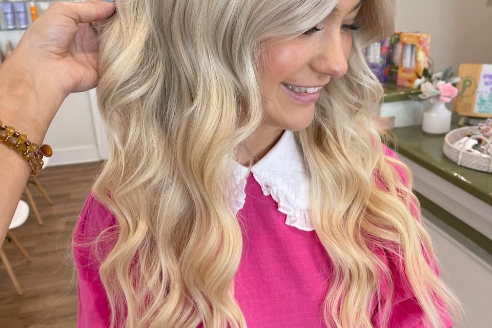 Long blonde curled waves with bright dimension after salon color and styling in Columbiana AL