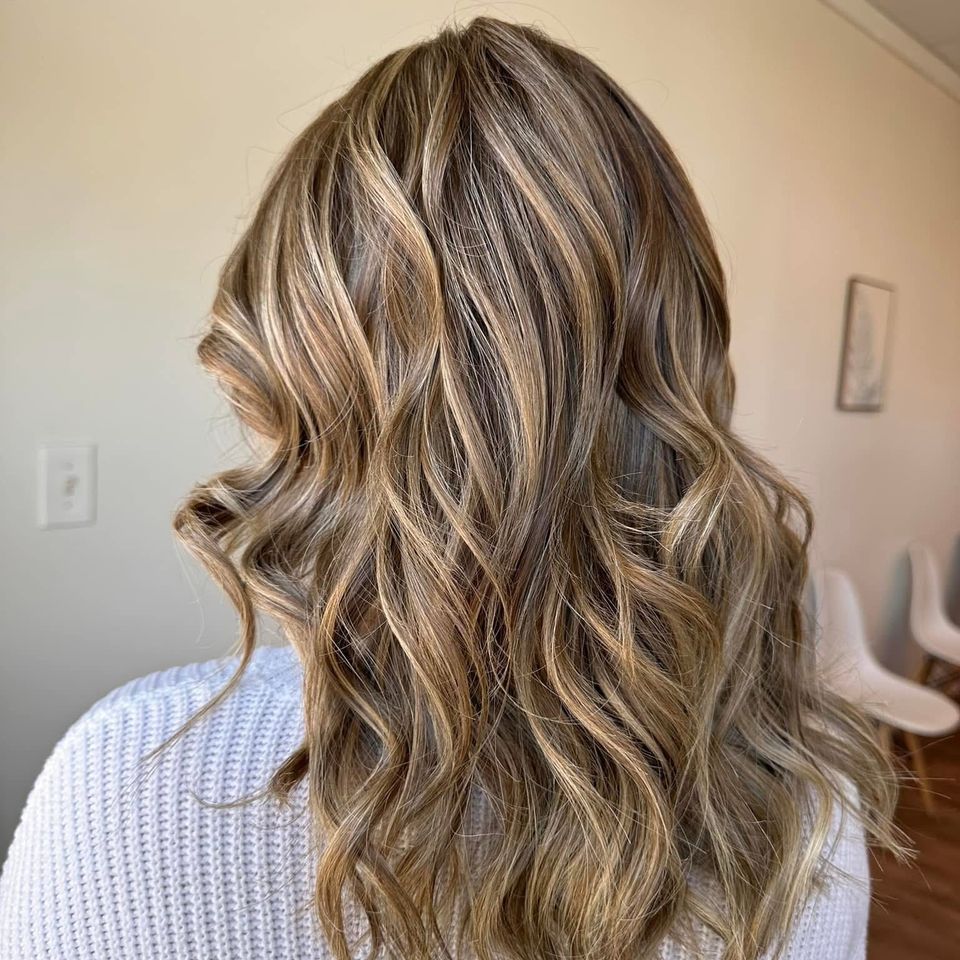 Medium wavy blonde hair with blended blonde highlights after color and styling in Columbiana AL